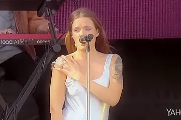 Attractive inked singer shows off one of her tits at a show - porn video